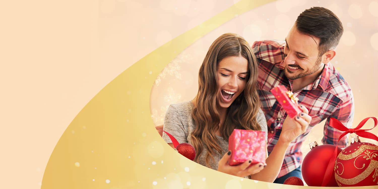 Young couple opening a gift certificate for Arthur Murray Dance Lessons